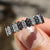 Black and white wedding band with hexagonal outline