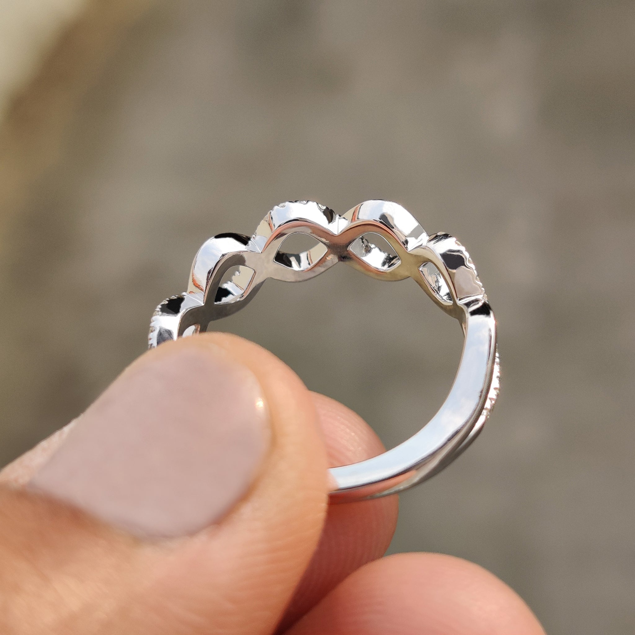 Round cut moissanite band with a twist detail, made for everyday wear.