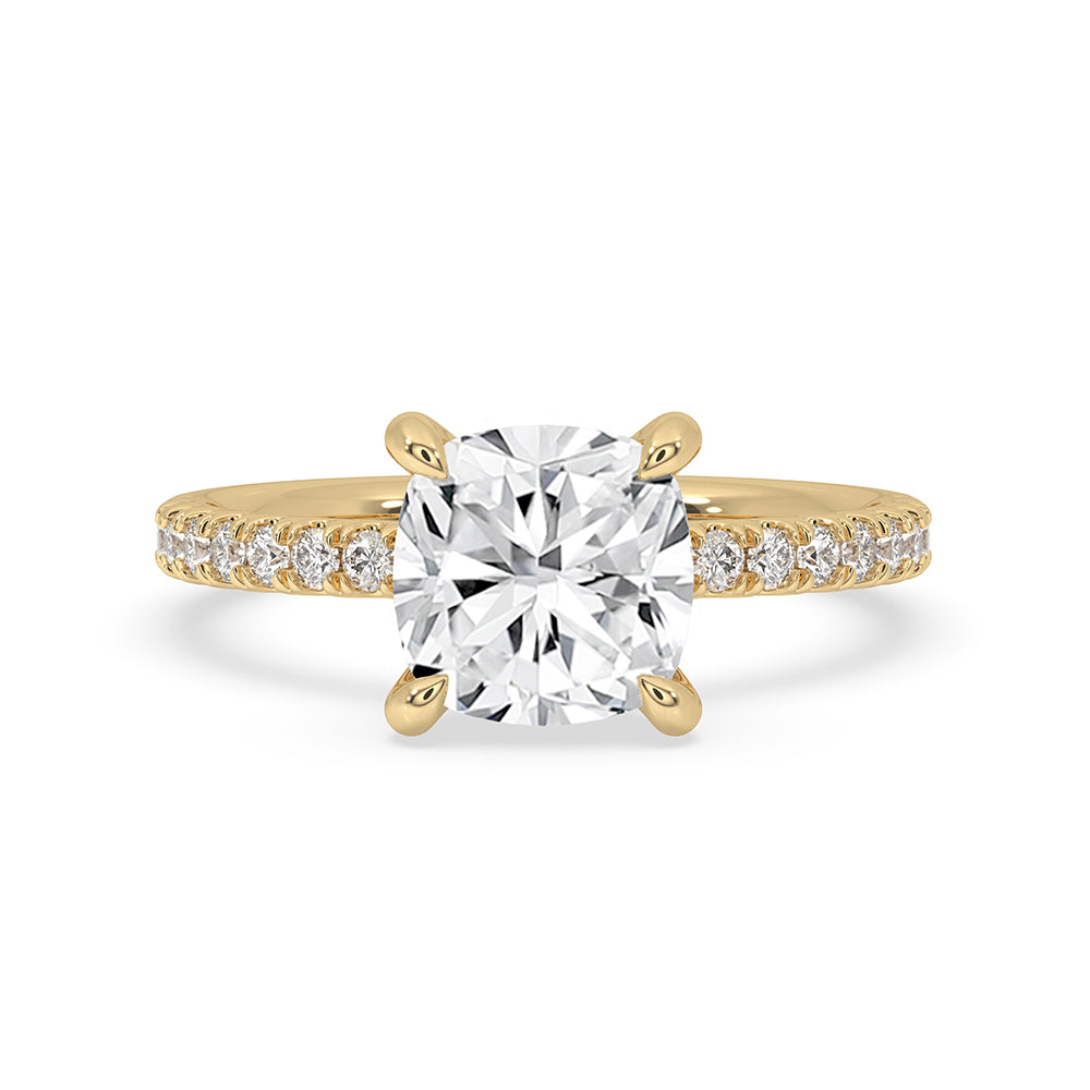 Cushion cut hidden halo engagement ring with pave setting in yellow gold.
