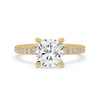 Cushion cut hidden halo engagement ring with pave setting in yellow gold.
