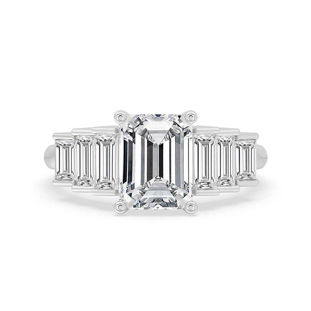 Emerald and baguette cut diamond ring in white gold.
