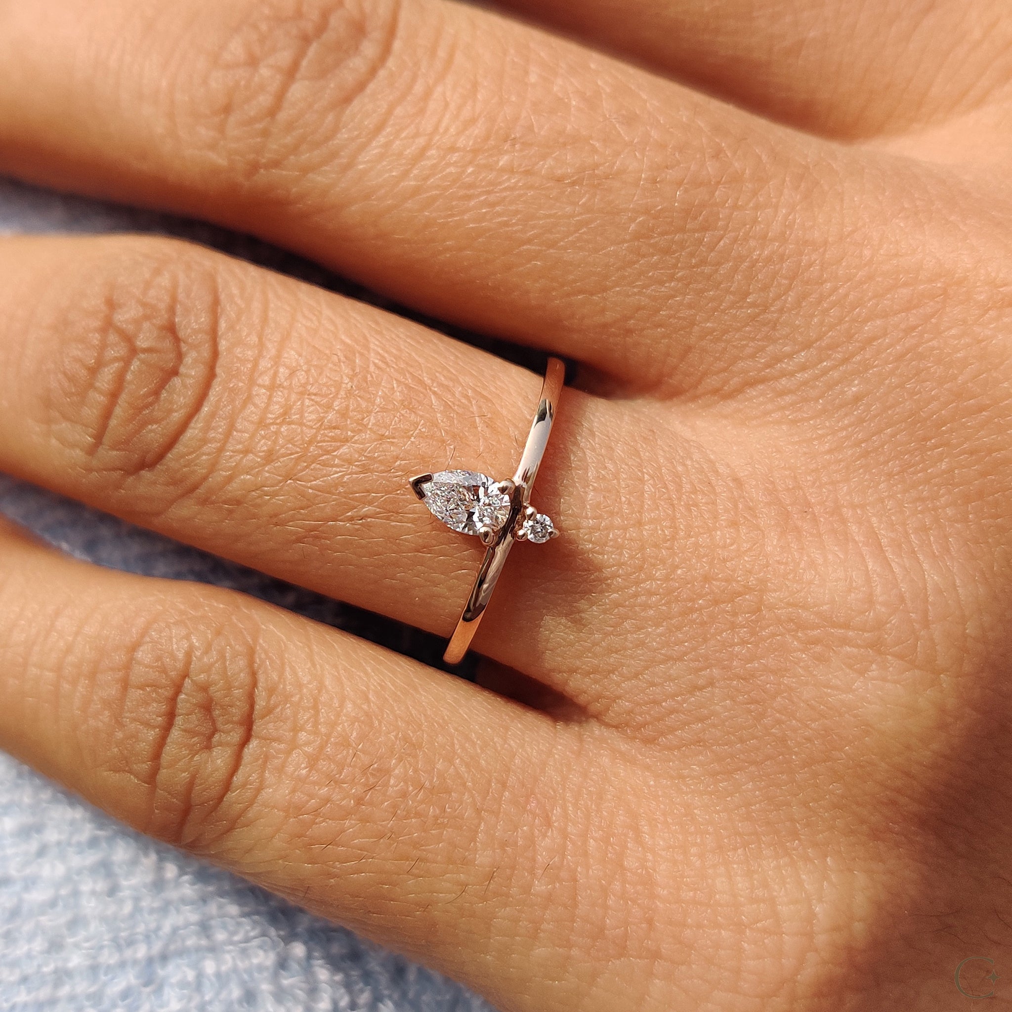 Rose gold ring featuring two sparkling diamonds.
