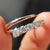 Open moissanite wedding band featuring round cut stones in a modern cuff design.