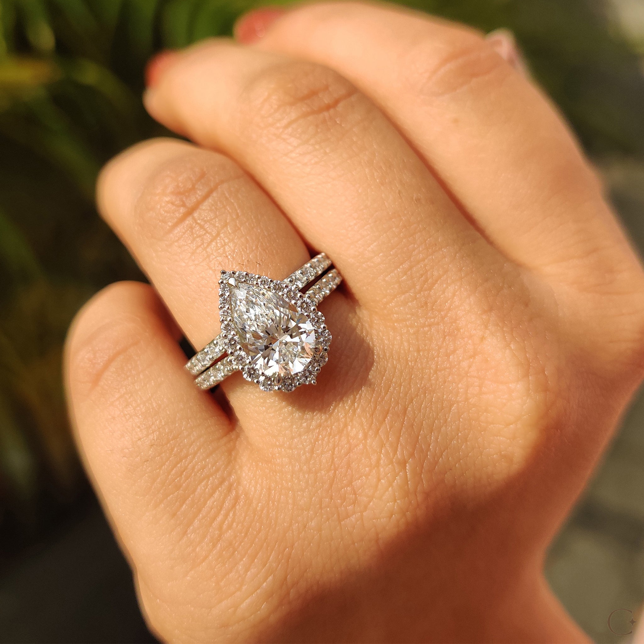 Pave band with a sparkling pear shaped halo ring.
