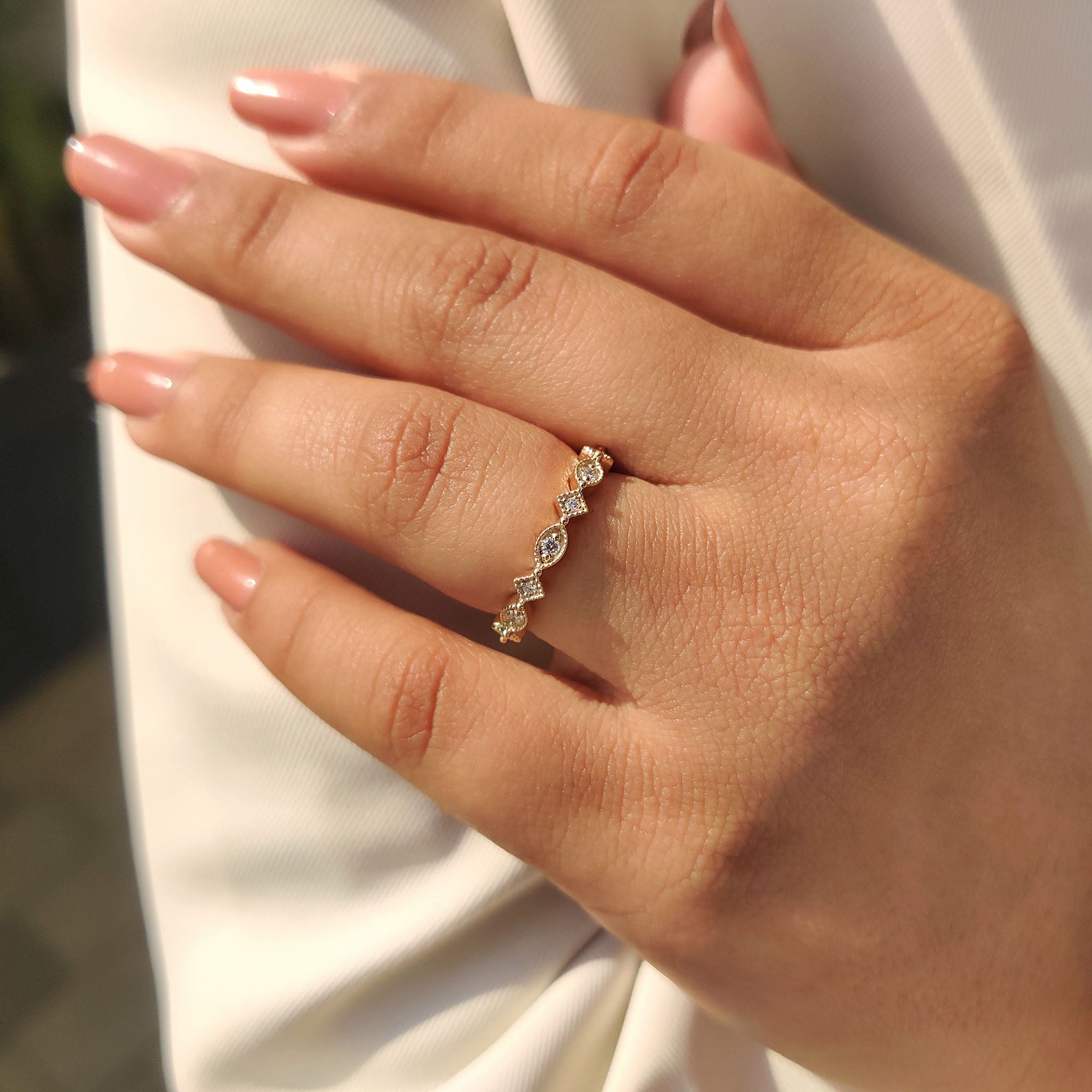 Yellow gold wedding band with marquise outline and lab grown diamonds.
