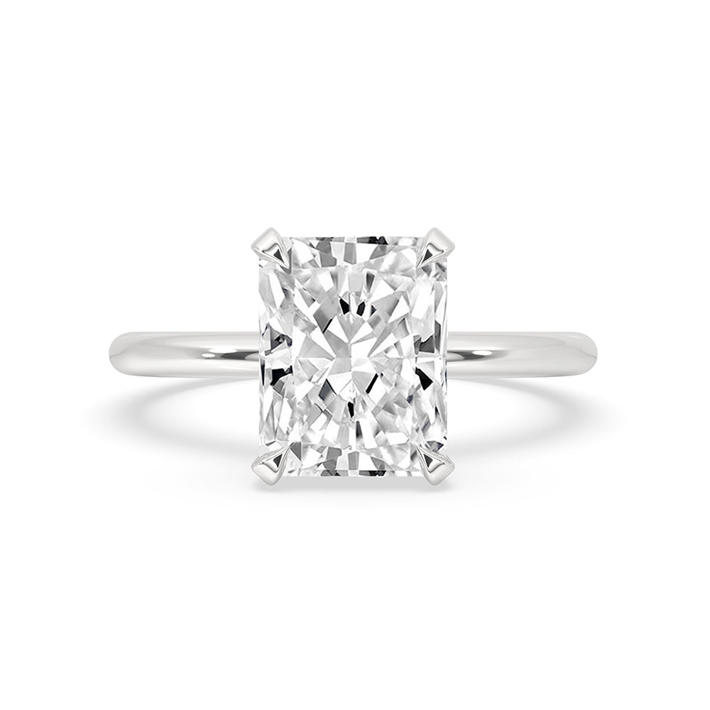 Radiant cut ring in a solitaire setting with white gold band.
