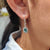 Oval cut earrings created in white gold with lever back earrings and handmade jewelry finish.
