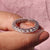 Full eternity wedding band shines next to white gold moissanite band.
