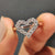Heart shape outline ring with round cut Moissanite set in a white gold band
