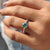 Choose a cyan blue round cut moissanite ring with a yellow gold ring for a fresh, modern twist.
