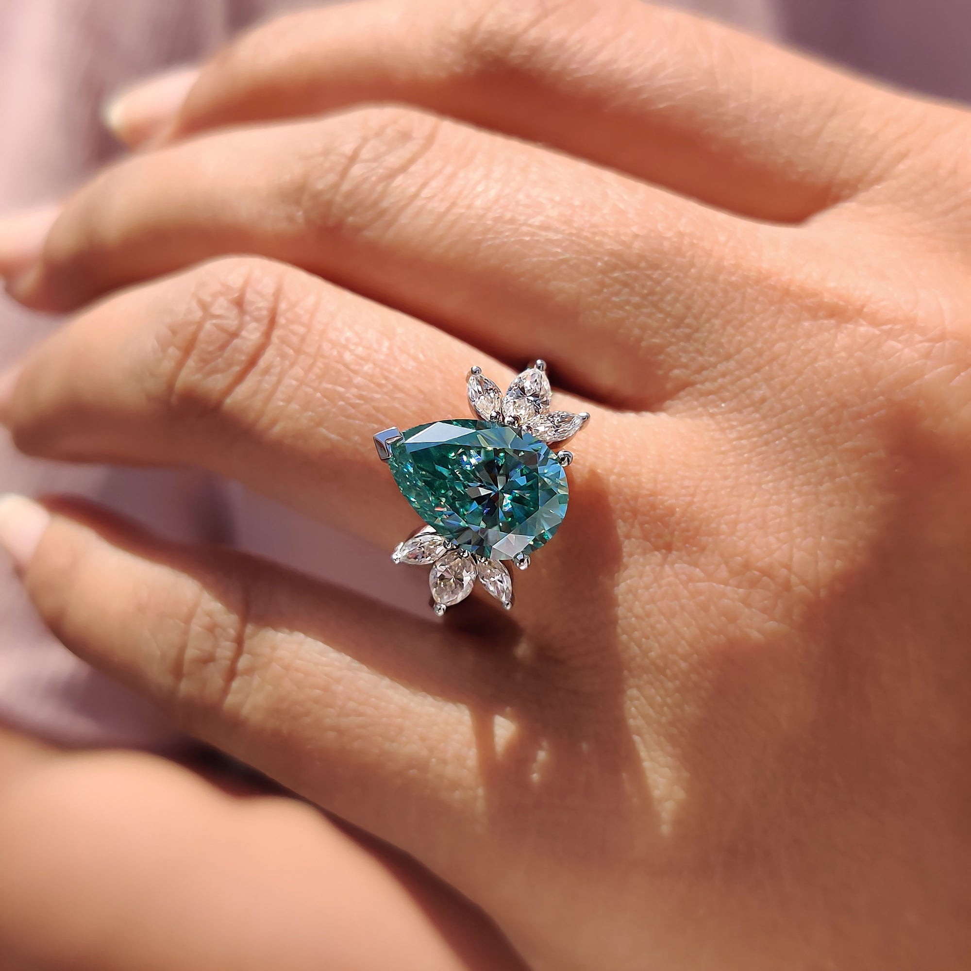 Best engagement ring choice with pear cut Moissanite and seven stone setting for extra sparkle.
