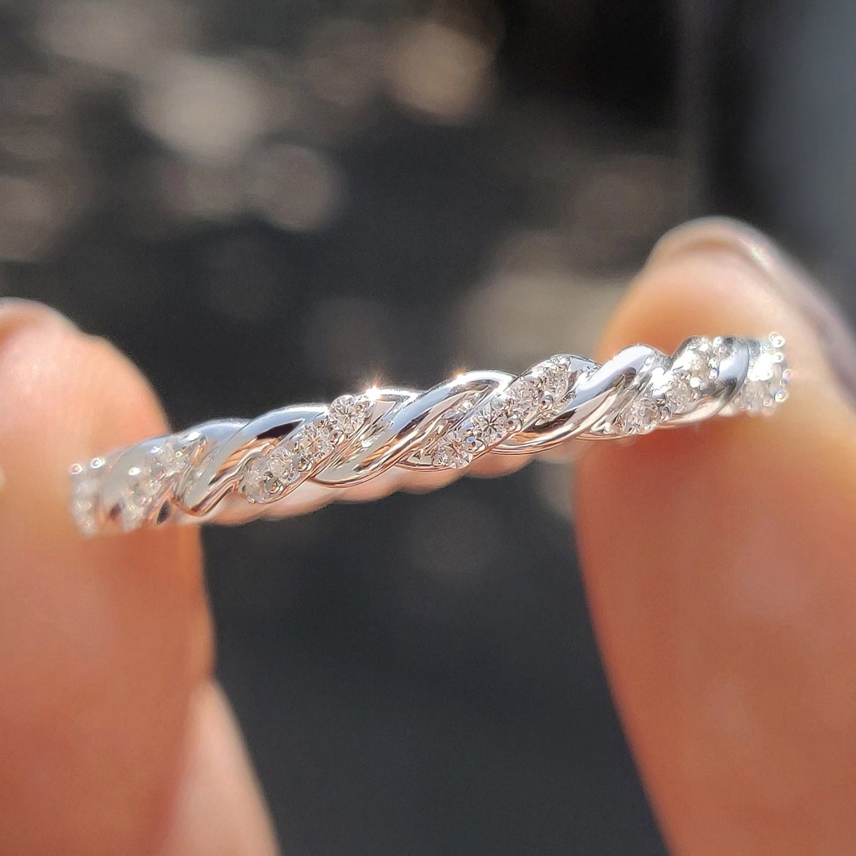 Twisted eternity band with round moissanite stones
