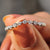 Curved moissanite wedding band with a round cut wedding band.

