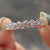 Bezel set wedding band with round moissanite.
