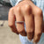 Round eternity band featuring moissanite stones encircling the band for continuous brilliance.