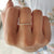 Round moissanite wedding band paired with simple moissanite band.
