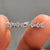 Eternity wedding band with round stones set in a white gold band.