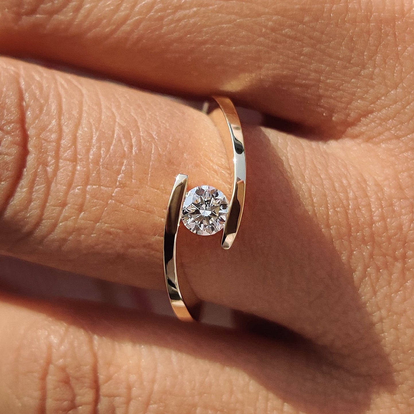 Bypass diamond ring with a sleek twisted design.
