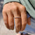 Moissanite eternity band paired with yellow gold wedding band.