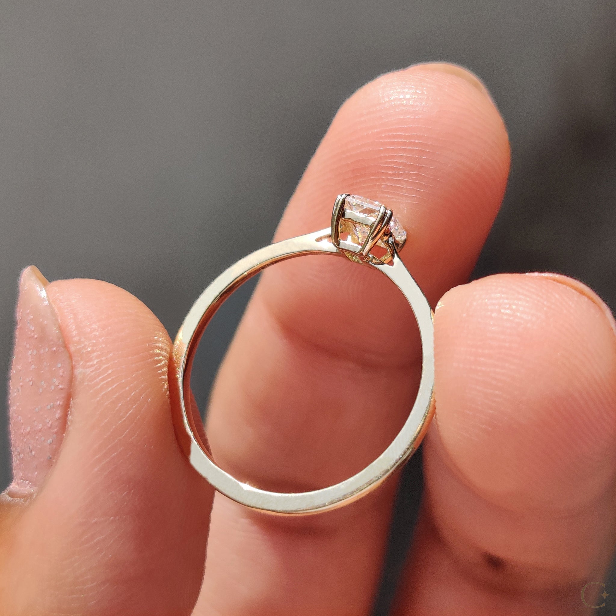 Carat Diamonds engagement ring with radiant cut and tapered shank.
