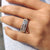 Round cut three row pave band in a structured white gold design.