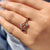 Round cut wedding band with double bezel set moissanite stones in yellow gold.
