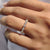Round cut moissanite wedding band handcrafted in yellow gold.