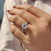Moissanite ring with four claw prong and pave band
