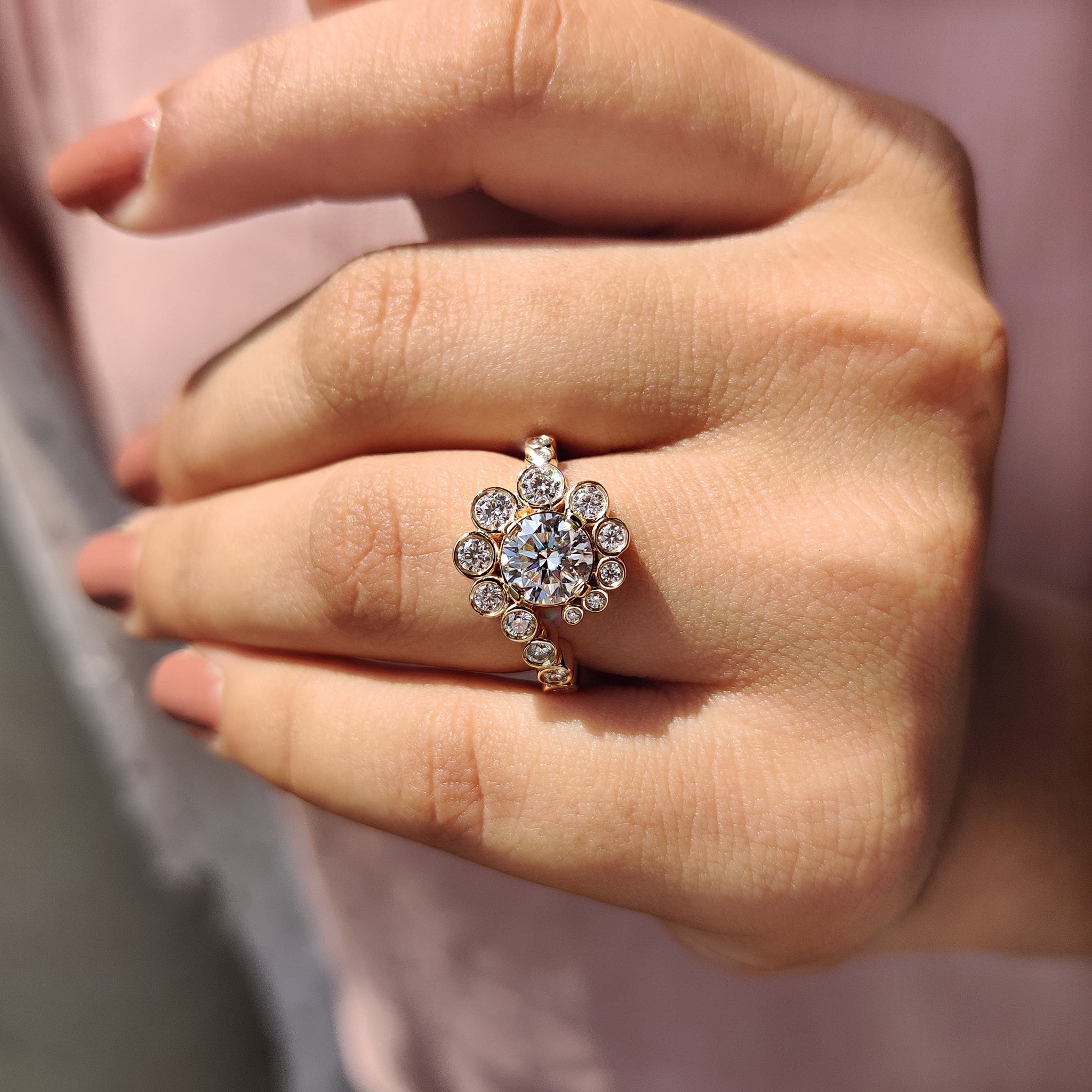 Custom engagement ring made with a round cut moissanite stone and yellow gold band.
