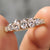 Oval cut wedding band crafted in yellow gold with half eternity moissanite.