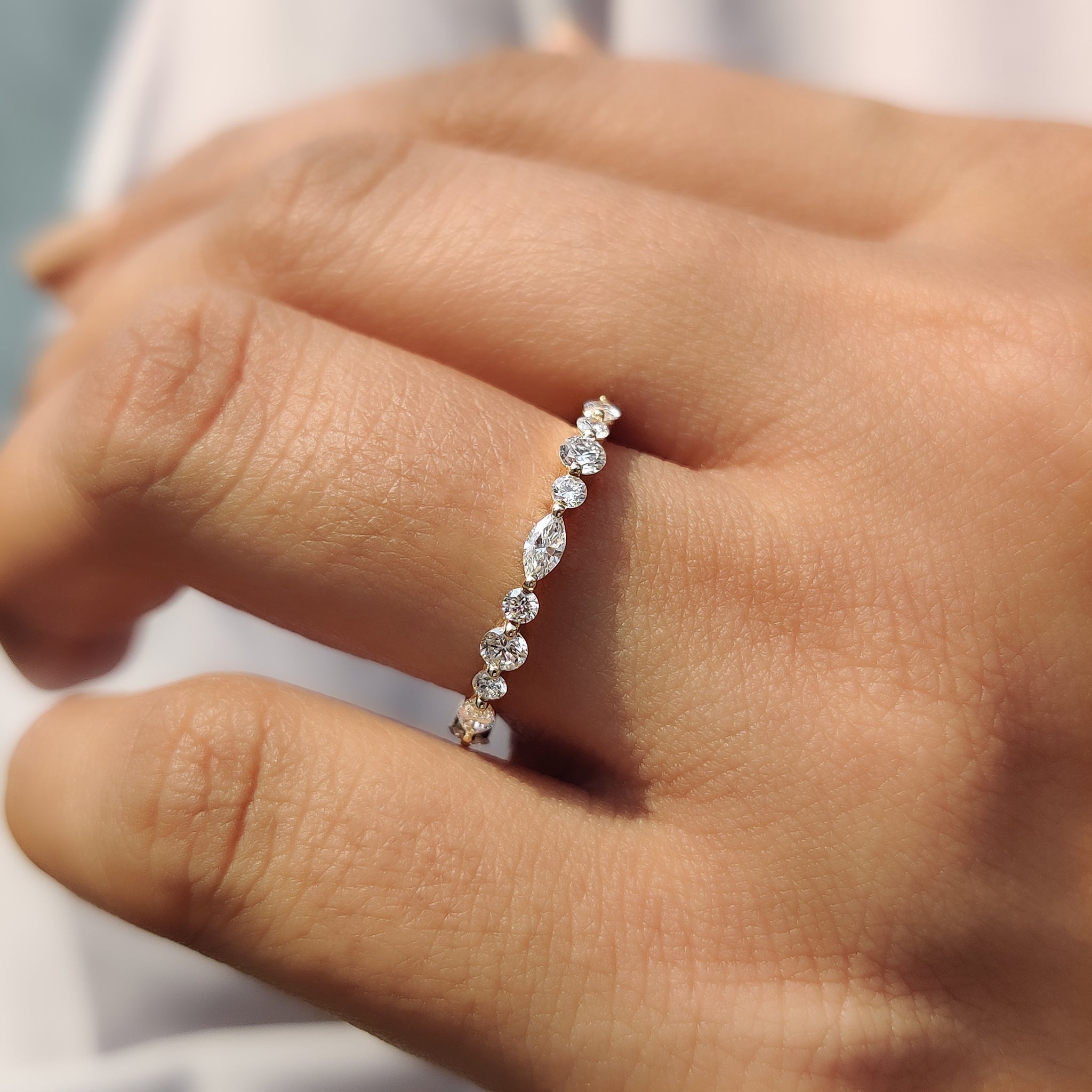 Yellow gold wedding band with shared prong setting.