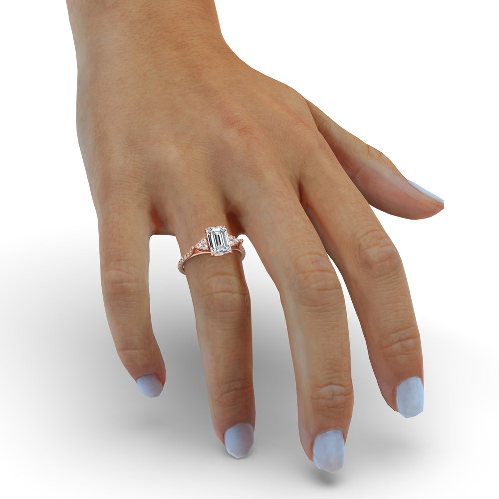 Emerald and diamond engagement ring with prong setting and antique style.

