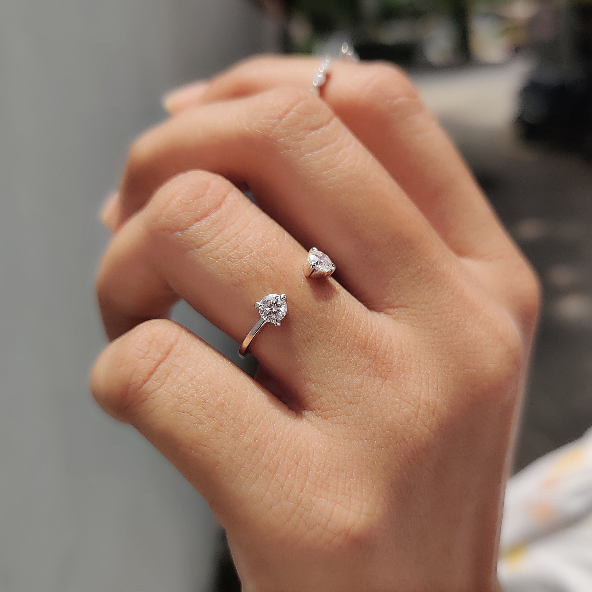 Round cut wedding band with two moissanite stones set at both ends of an open band.
