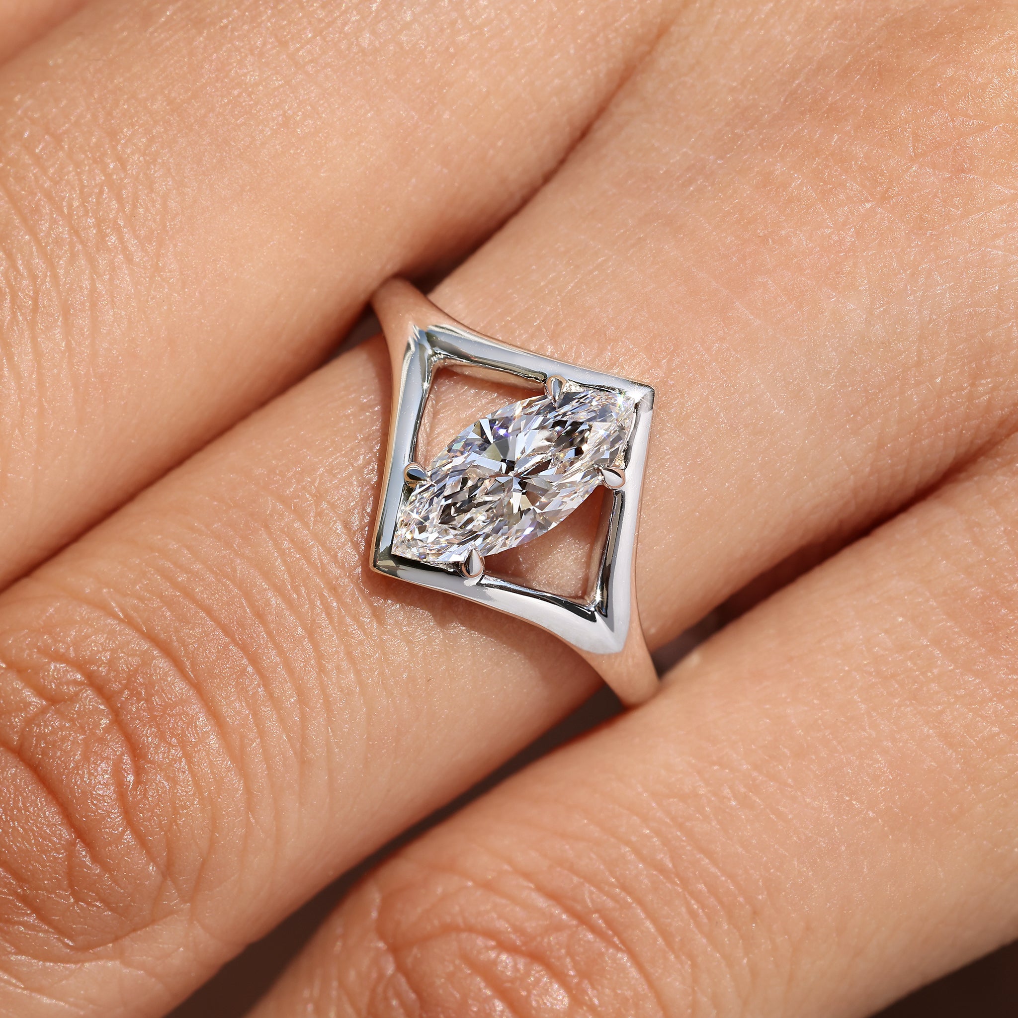 Marquise solitaire diamond ring with four claw prong setting.
