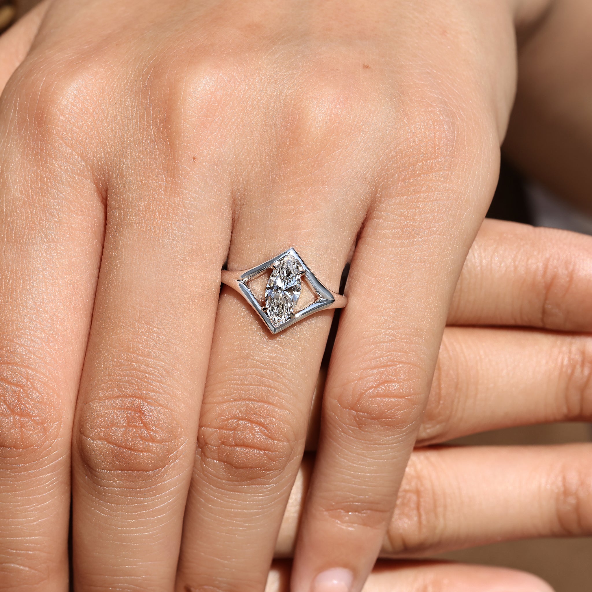 Marquise diamond ring with four claw prong setting.
