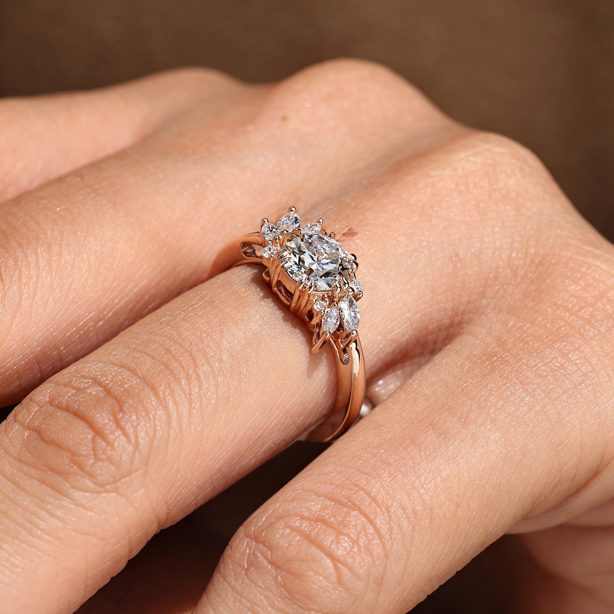 Round diamond ring with round side stones cluster setting.
