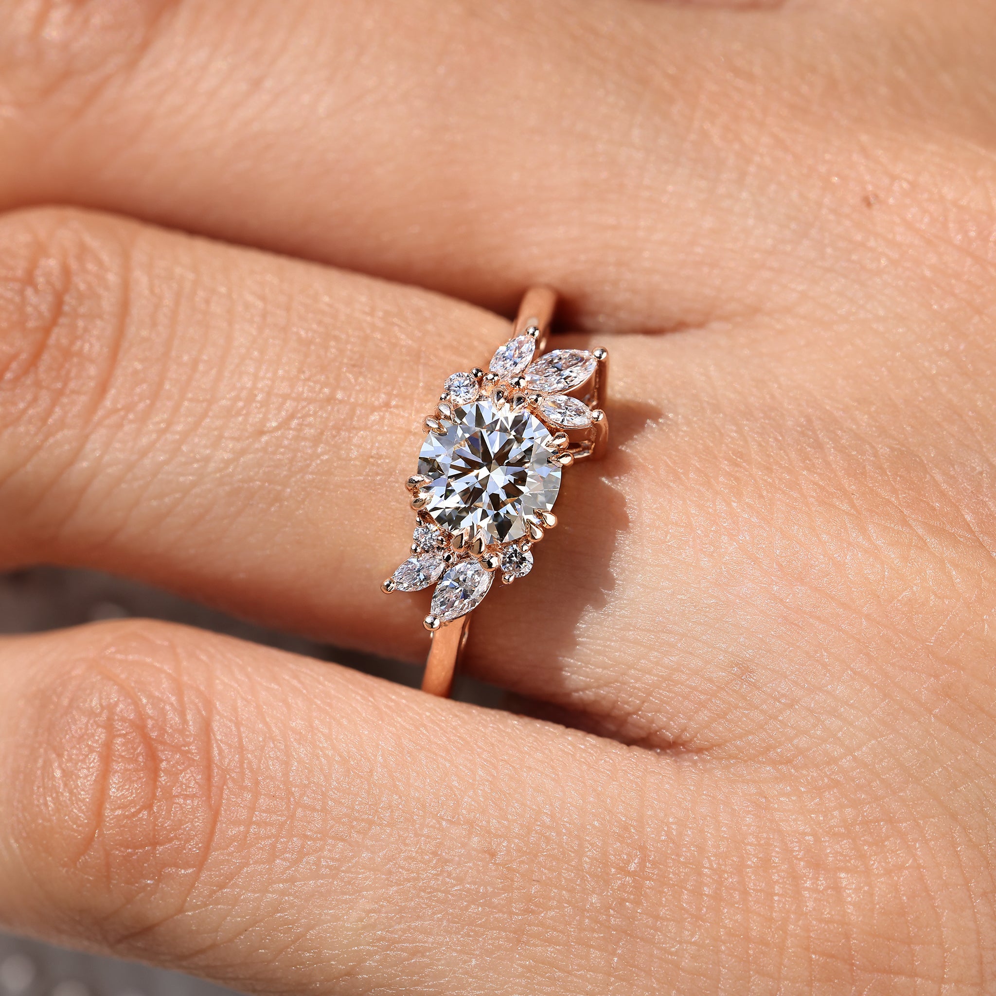 Round diamond ring with marquise and round accents.
