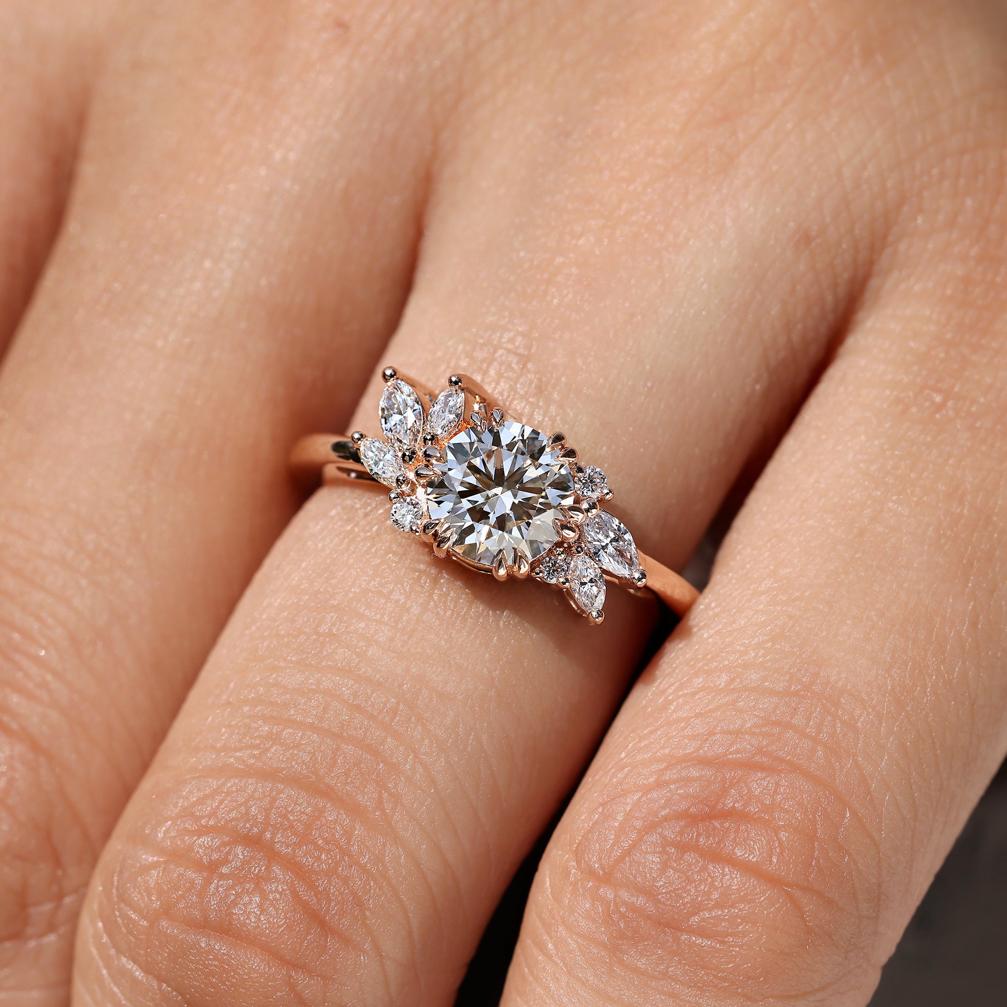 Carat Diamonds round diamond ring with side stones.
