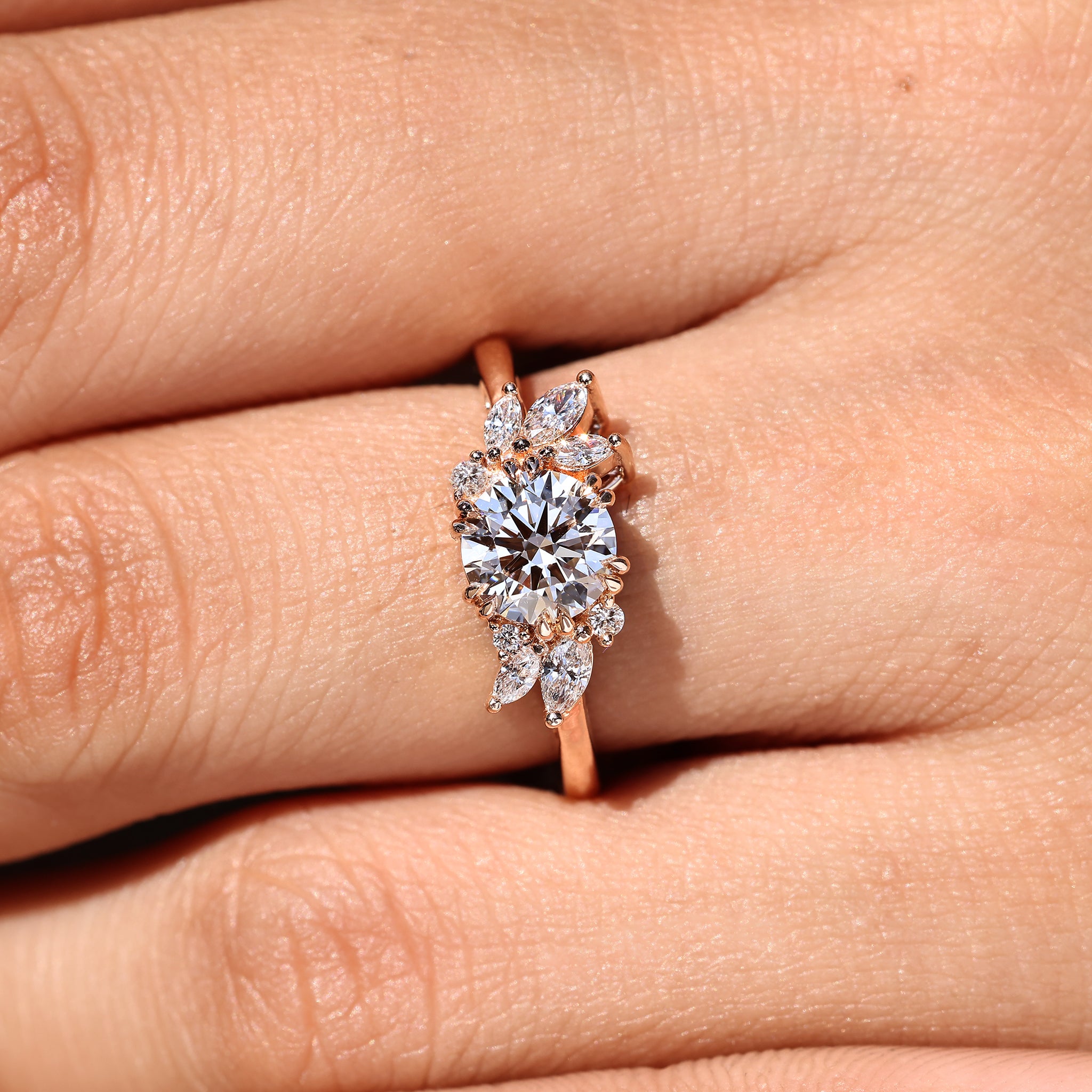 Cluster setting round diamond engagement ring with prongs.
