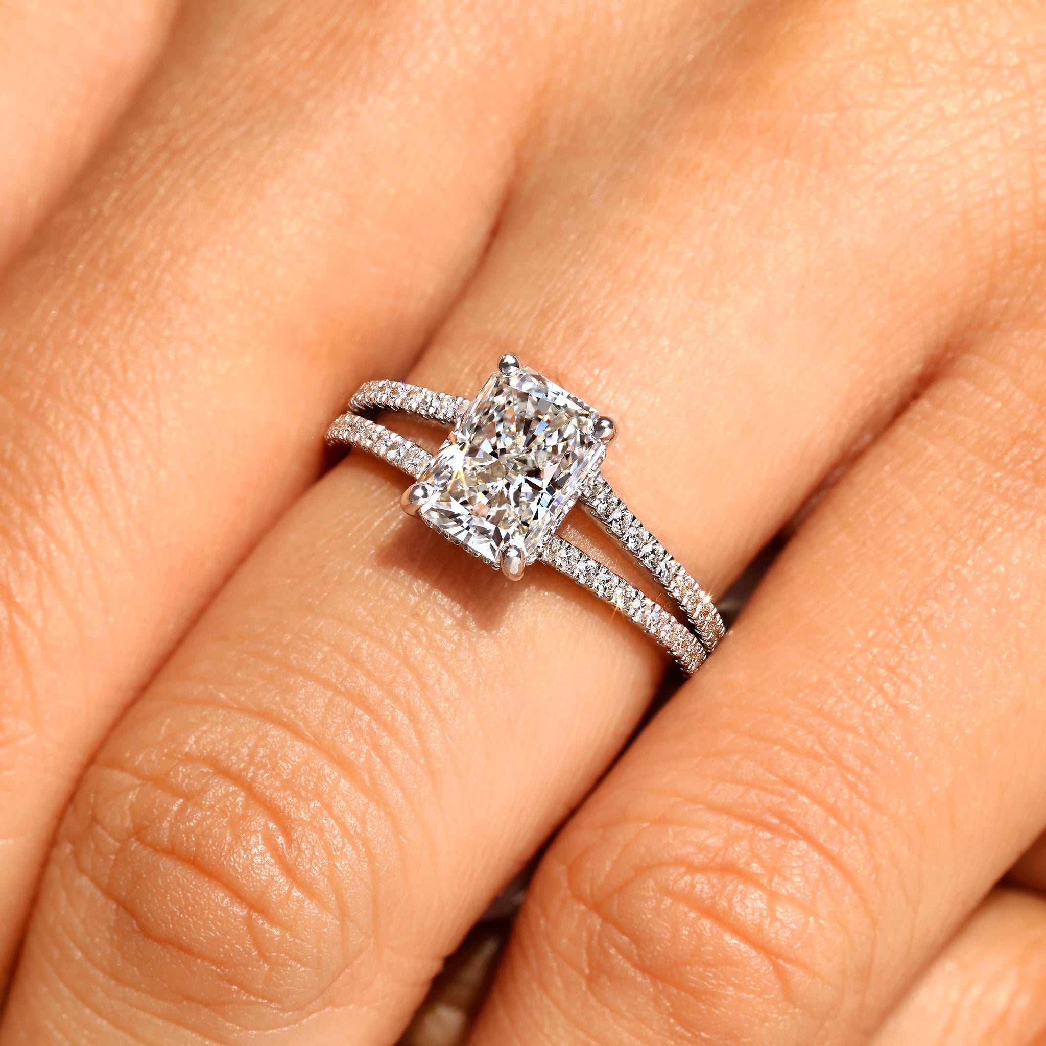 Split shank radiant cut diamond engagement ring.
