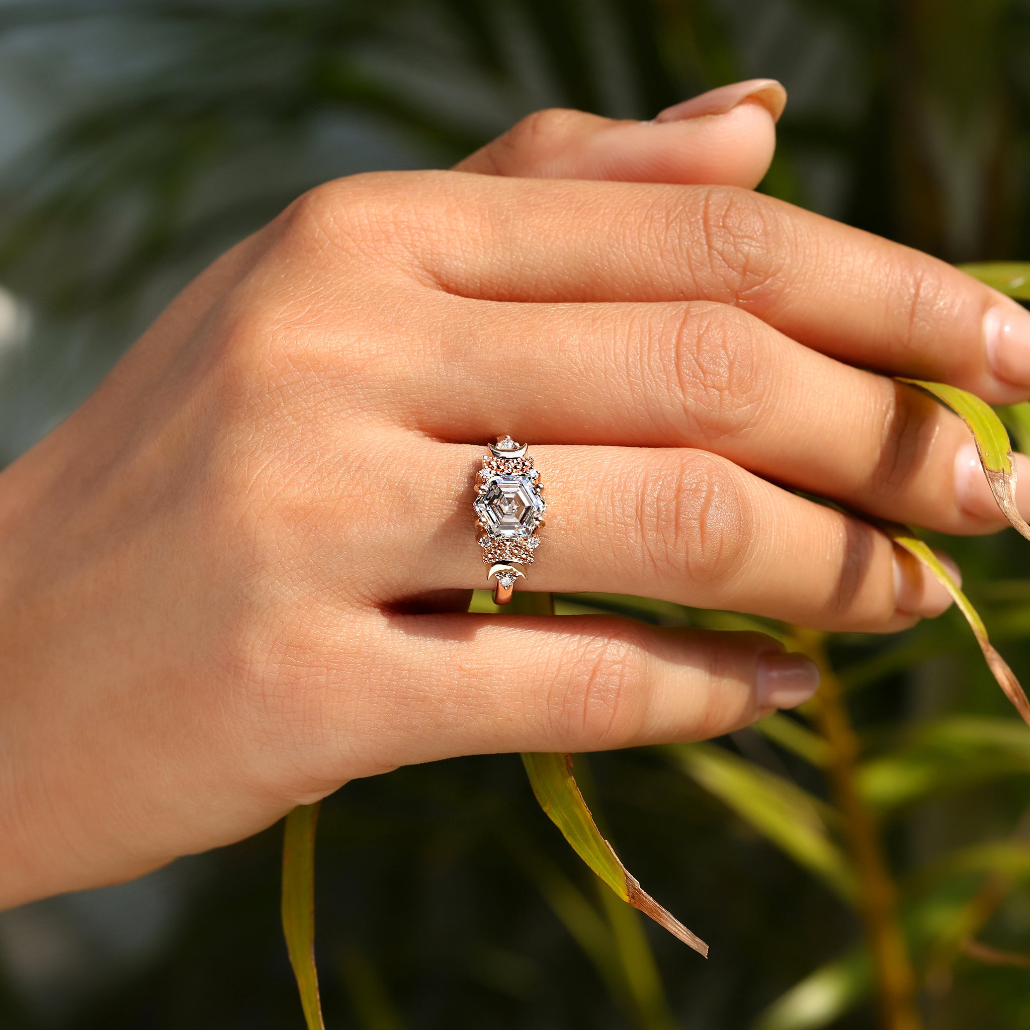Hexagon step cut diamond ring with round side stones.
