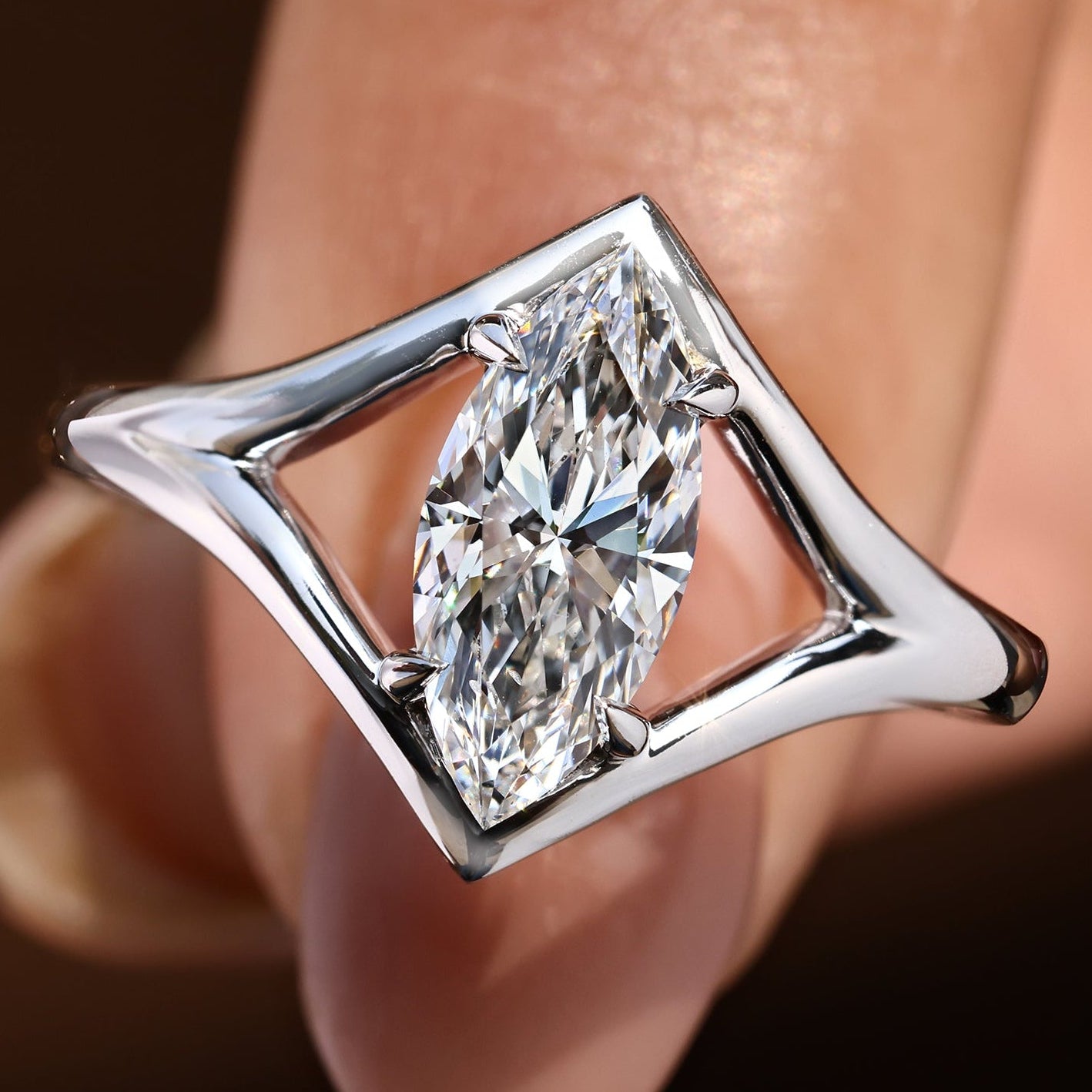 Marquise diamond ring in solitaire style with split shank.
