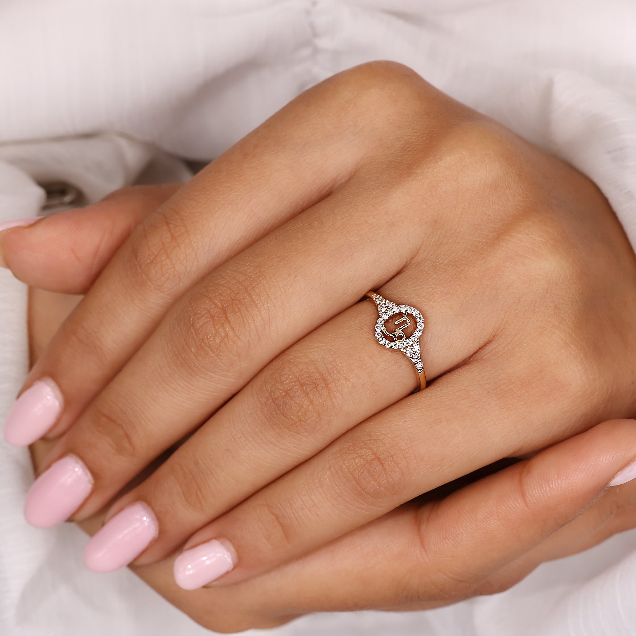 Carat Diamonds Capricorn ring with halo design and yellow gold finish.
