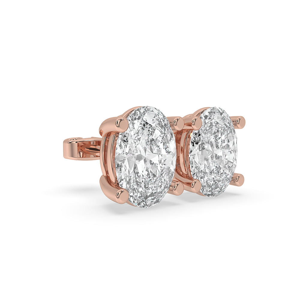 Diamond solitaire earrings designed as elegant gold stud earrings.
