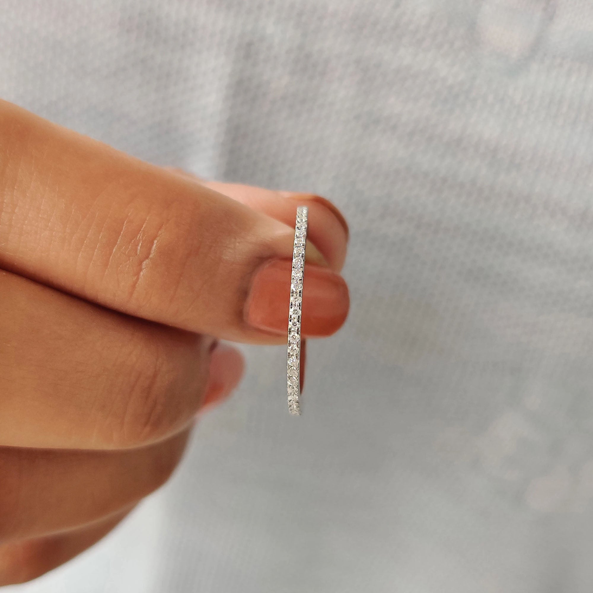 White gold band featuring moissanite stones for a radiant finish.
