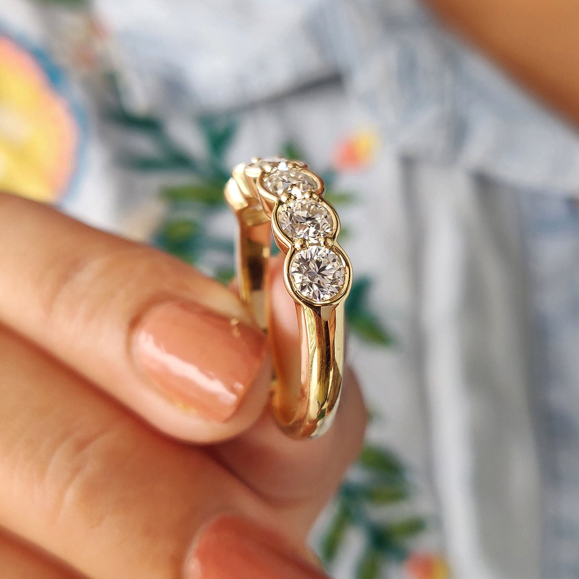 Custom wedding band in yellow gold with round cut moissanite stones.
