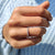 Bezel setting wedding band designed to protect each round stone while enhancing shine.