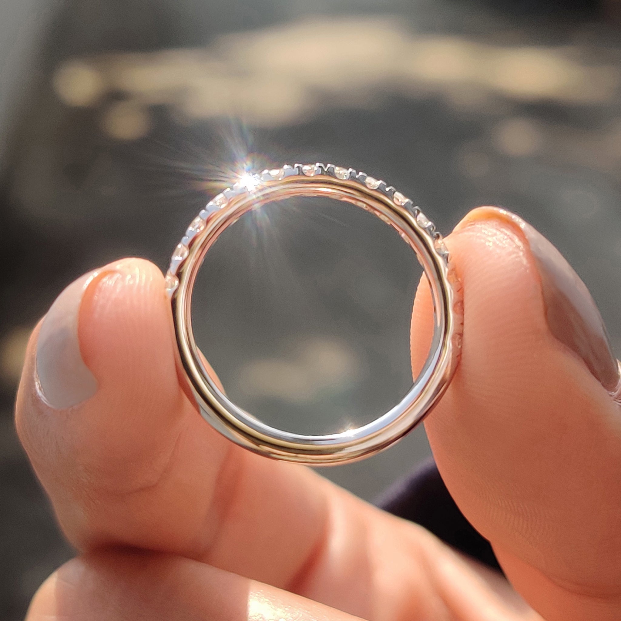 Round Moissanite Wedding Band with a sleek half eternity band design in white gold.