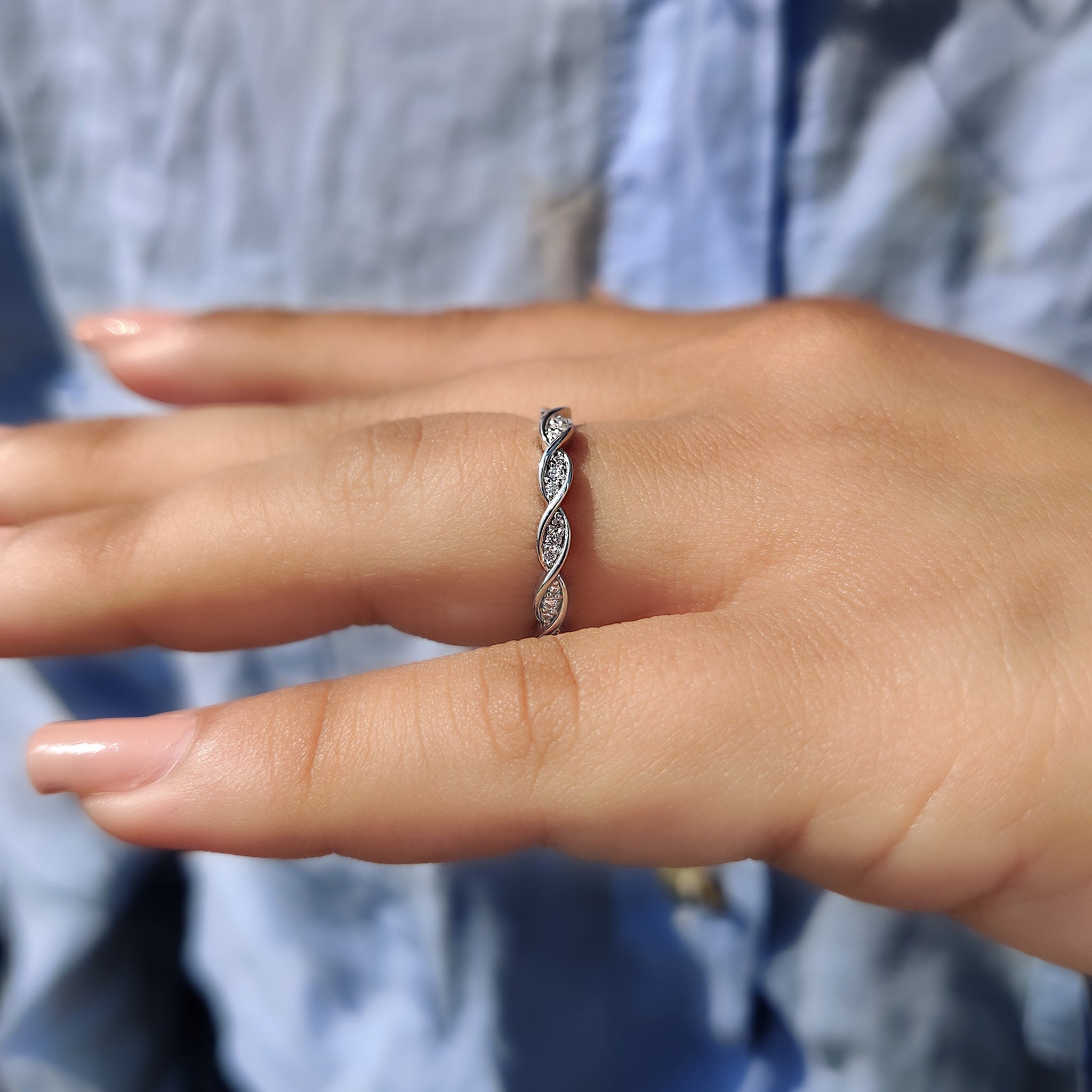 Twisted moissanite band with a unique design.
