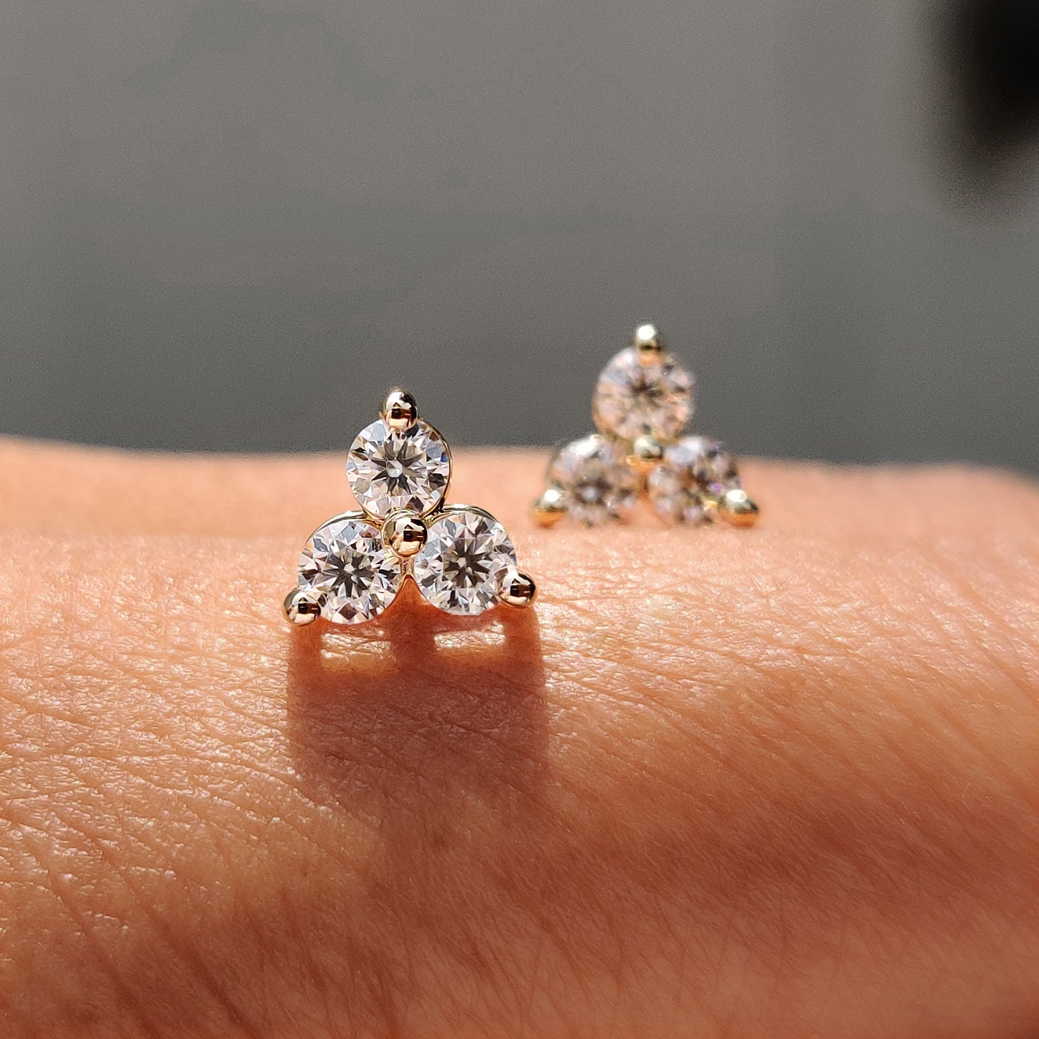 Round cut Moissanite earrings styled in custom earrings layout with handmade jewelry.
